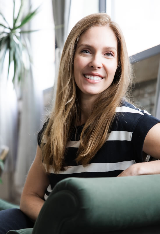 dr jacqueline titus sitting in chair facing front smiling